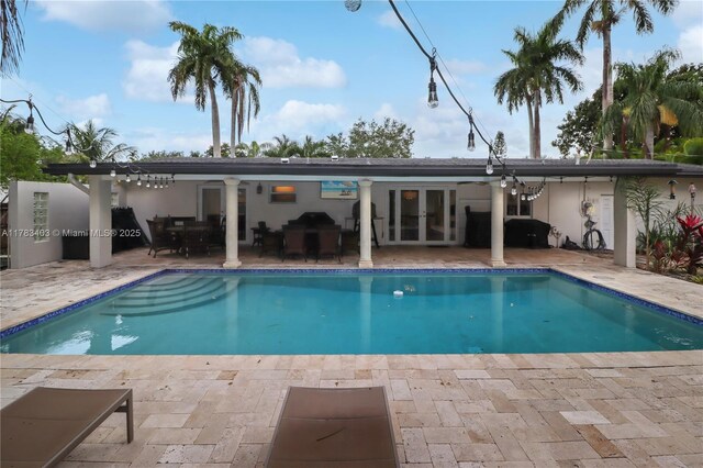 8435 SW 157th St, Palmetto Bay, FL 33157 - outdoor pool with french doors and a patio area