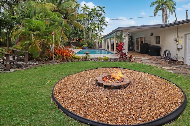 8435 SW 157th St, Palmetto Bay, FL 33157 - view of yard with a fenced in pool, a patio area, a fire pit, and fence
