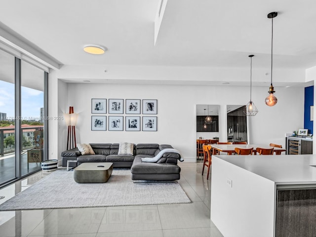 living area featuring floor to ceiling windows and light tile patterned floors