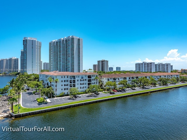 drone / aerial view featuring a water view and a view of city