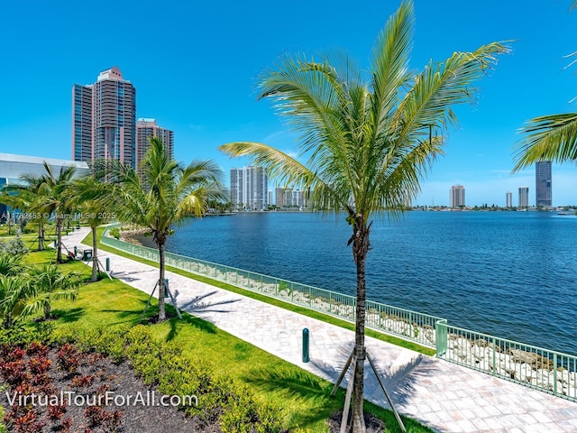 property view of water featuring fence and a city view