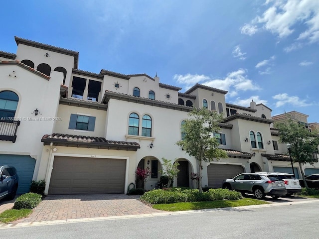 3142 NW 124th Way, Sunrise, FL 33323 - view of front of house featuring an attached garage, a tiled roof, stucco siding, and decorative driveway