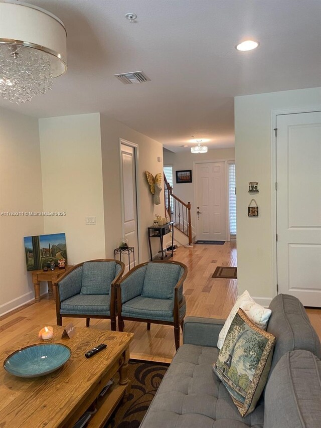 3142 NW 124th Way, Sunrise, FL 33323 - living room featuring light wood-type flooring, stairway, recessed lighting, baseboards, and a chandelier