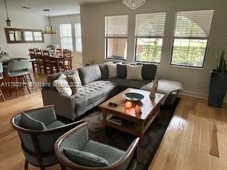 3142 NW 124th Way, Sunrise, FL 33323 - living area featuring wood finished floors and baseboards