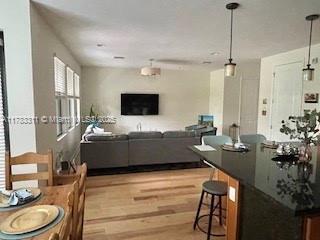 3142 NW 124th Way, Sunrise, FL 33323 - living room featuring light wood finished floors