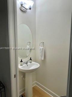 3142 NW 124th Way, Sunrise, FL 33323 - bathroom featuring baseboards and wood finished floors