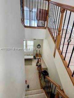 3142 NW 124th Way, Sunrise, FL 33323 - staircase featuring baseboards and a high ceiling