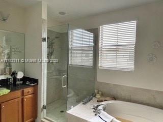 3142 NW 124th Way, Sunrise, FL 33323 - bathroom with vanity, a garden tub, and a stall shower