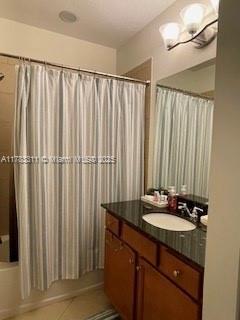 3142 NW 124th Way, Sunrise, FL 33323 - bathroom featuring vanity, shower / tub combo with curtain, and tile patterned floors