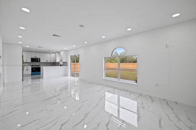 9150 Genesee St, Port Charlotte, FL 33981 - unfurnished living room featuring recessed lighting, visible vents, and marble finish floor