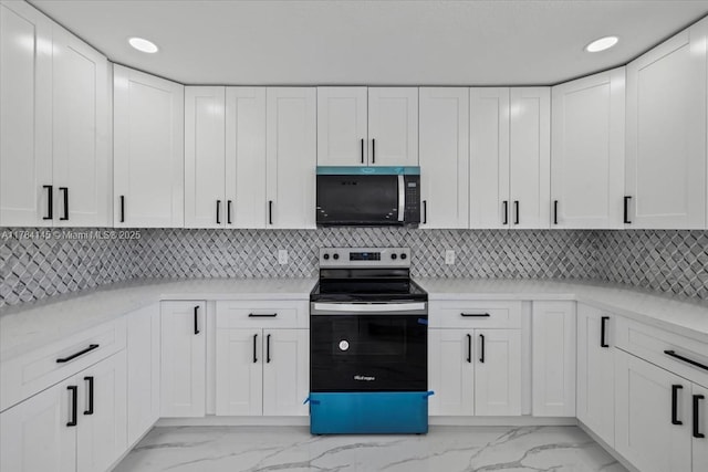 9150 Genesee St, Port Charlotte, FL 33981 - kitchen with white cabinets, marble finish floor, and stainless steel range with electric stovetop