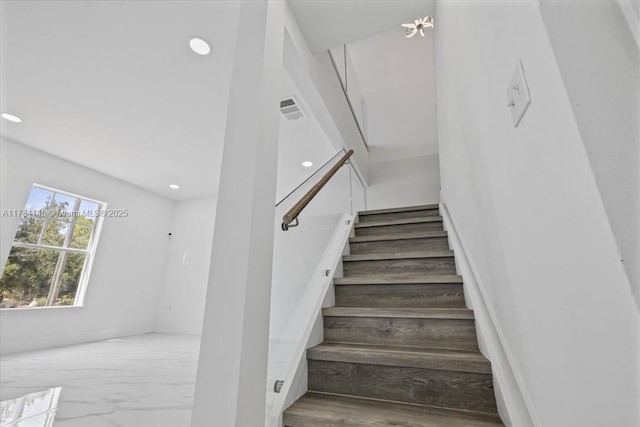 9150 Genesee St, Port Charlotte, FL 33981 - staircase featuring recessed lighting, visible vents, and marble finish floor