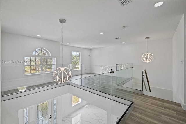 9150 Genesee St, Port Charlotte, FL 33981 - hall featuring a chandelier, recessed lighting, an upstairs landing, visible vents, and wood finished floors
