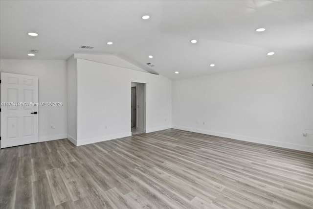 9150 Genesee St, Port Charlotte, FL 33981 - spare room featuring light wood-style floors, vaulted ceiling, visible vents, recessed lighting, and baseboards