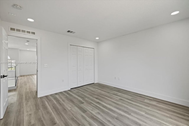 9150 Genesee St, Port Charlotte, FL 33981 - unfurnished bedroom with recessed lighting, visible vents, baseboards, and wood finished floors