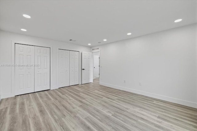 9150 Genesee St, Port Charlotte, FL 33981 - unfurnished bedroom featuring light wood-type flooring, multiple closets, recessed lighting, and baseboards