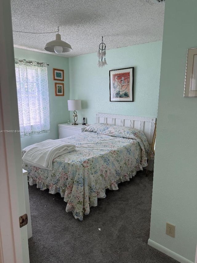 carpeted bedroom with a textured ceiling
