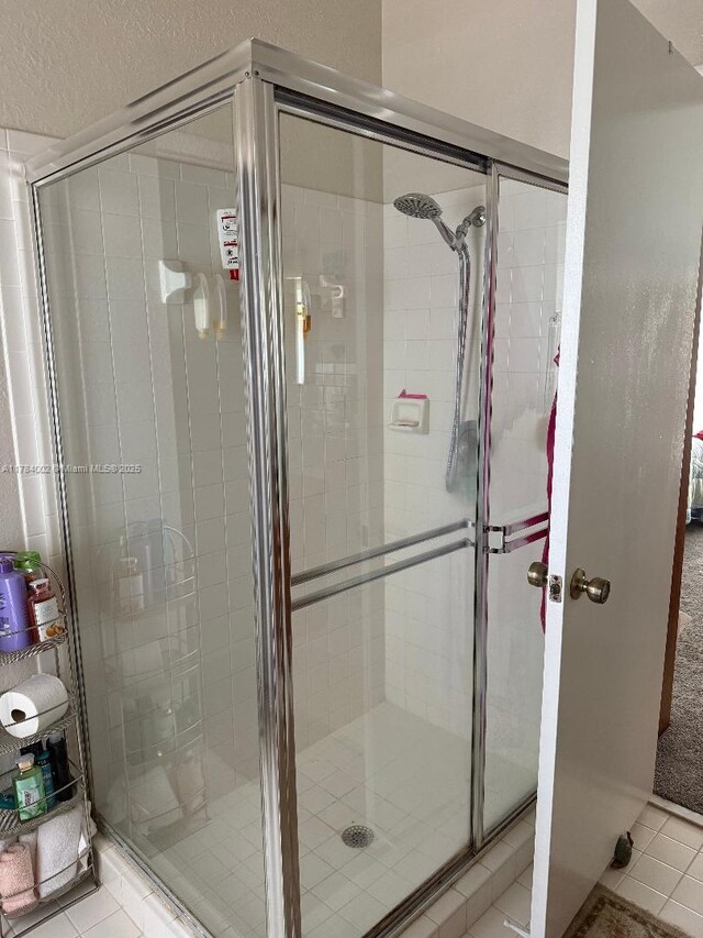 bathroom featuring a stall shower and tile patterned flooring