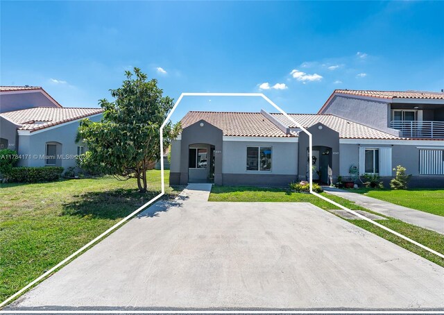 8352 SW 148th Ave, Miami, FL 33193 - mediterranean / spanish home with a front yard, a tile roof, and stucco siding