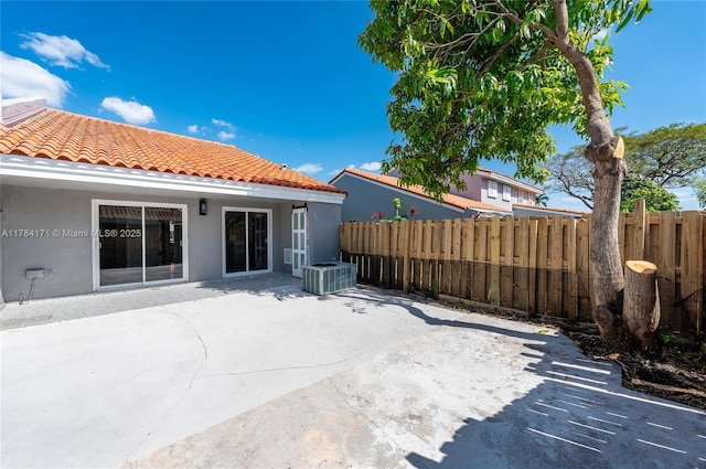 8352 SW 148th Ave, Miami, FL 33193 - back of house featuring central AC unit, a tiled roof, fence, and stucco siding
