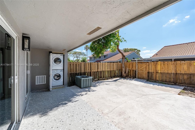 8352 SW 148th Ave, Miami, FL 33193 - view of patio / terrace with cooling unit, stacked washing maching and dryer, fence private yard, and visible vents