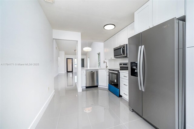 8352 SW 148th Ave, Miami, FL 33193 - kitchen with light tile patterned floors, light countertops, white cabinets, and stainless steel appliances