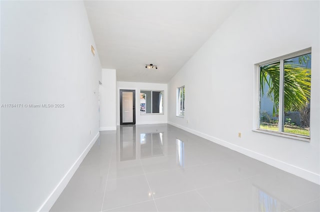 8352 SW 148th Ave, Miami, FL 33193 - unfurnished room featuring baseboards, tile patterned flooring, and lofted ceiling