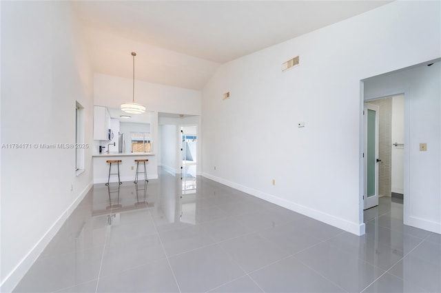 8352 SW 148th Ave, Miami, FL 33193 - interior space with visible vents, baseboards, light tile patterned flooring, and vaulted ceiling
