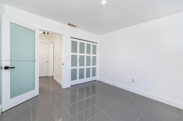 8352 SW 148th Ave, Miami, FL 33193 - empty room featuring visible vents, baseboards, and dark tile patterned floors
