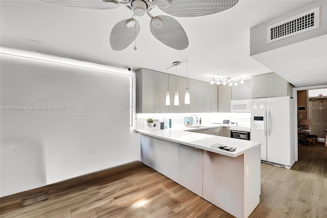 322 Taylor St Unit 1D, Hollywood, FL 33019 - kitchen featuring white appliances, a peninsula, light countertops, light wood finished floors, and ceiling fan