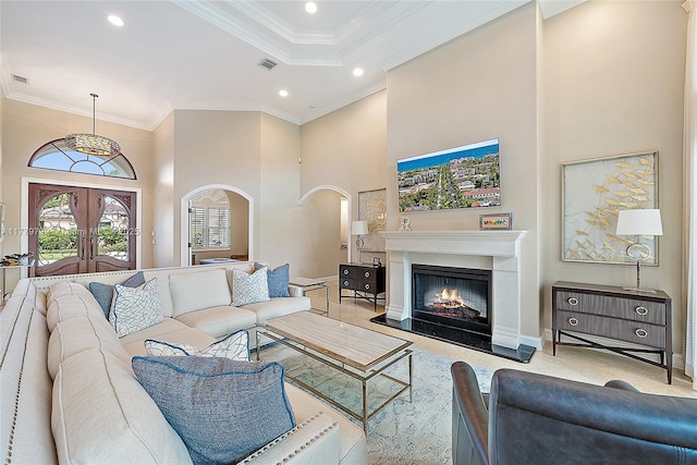 living room with visible vents, arched walkways, a high ceiling, crown molding, and recessed lighting