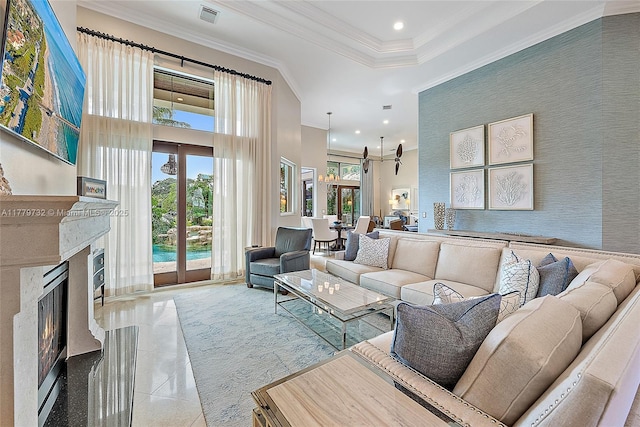 living room with a fireplace, tile patterned flooring, french doors, crown molding, and visible vents