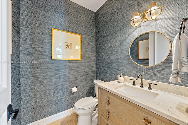 half bath with tile patterned floors, toilet, and vanity