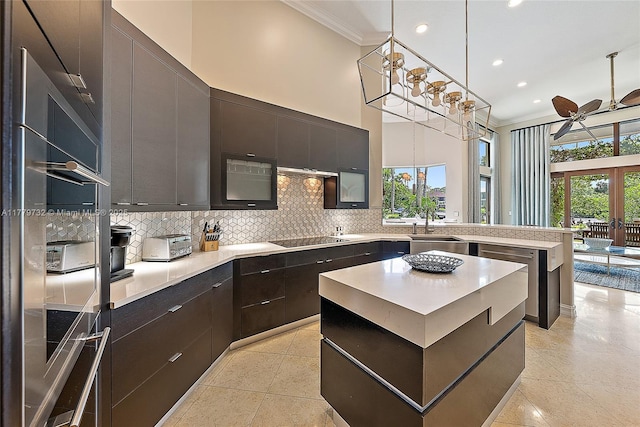 kitchen with a peninsula, crown molding, recessed lighting, stainless steel appliances, and decorative backsplash