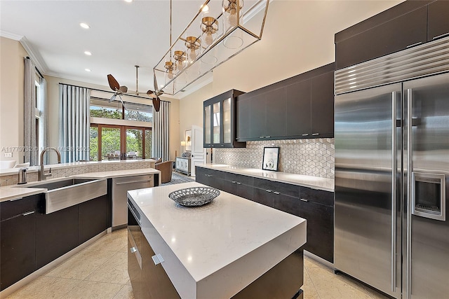 kitchen with modern cabinets, recessed lighting, appliances with stainless steel finishes, a sink, and decorative backsplash