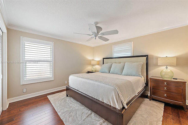 bedroom with hardwood / wood-style flooring, baseboards, ornamental molding, and ceiling fan