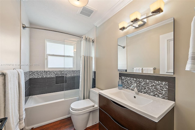 bathroom with ornamental molding, shower / bath combo, toilet, visible vents, and wood finished floors