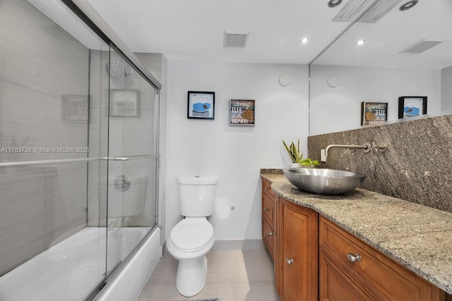 1918 Brickell Ave Unit 204, Miami, FL 33129 - full bath featuring toilet, vanity, decorative backsplash, enclosed tub / shower combo, and baseboards