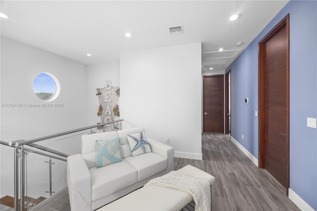 living room featuring recessed lighting, wood finished floors, visible vents, and baseboards