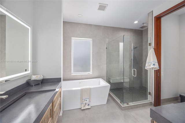 bathroom with visible vents, recessed lighting, a freestanding tub, a shower stall, and vanity