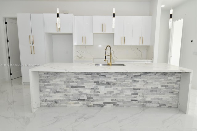 103 Scott Ave, Lehigh Acres, FL 33936 - kitchen with a sink, light marble finish floors, a large island with sink, and white cabinetry