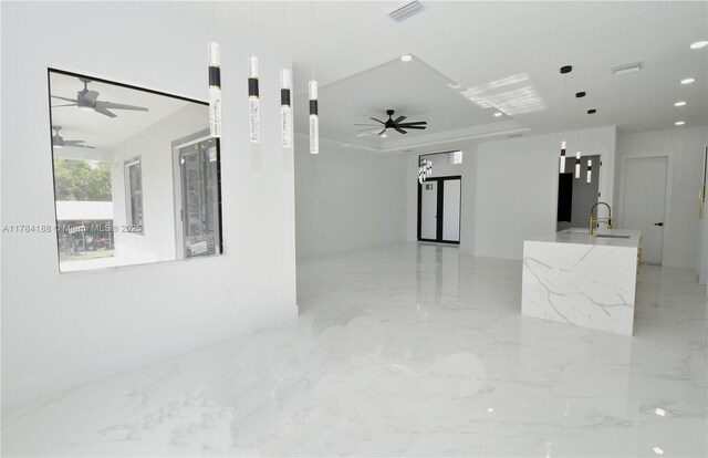 103 Scott Ave, Lehigh Acres, FL 33936 - unfurnished living room featuring a ceiling fan, a sink, light marble finish flooring, and recessed lighting