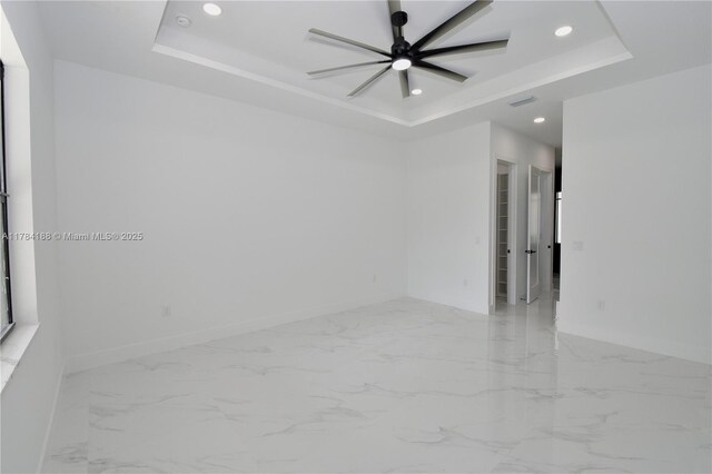 103 Scott Ave, Lehigh Acres, FL 33936 - spare room featuring a raised ceiling, recessed lighting, baseboards, and marble finish flooring