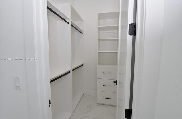 103 Scott Ave, Lehigh Acres, FL 33936 - walk in closet featuring light marble finish flooring