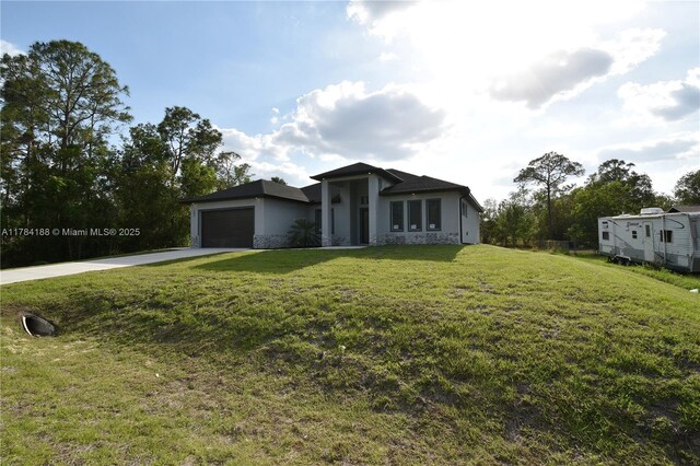 103 Scott Ave, Lehigh Acres, FL 33936 - view of front of home featuring stucco siding, a garage, driveway, and a front yard