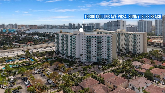 birds eye view of property with a water view and a city view