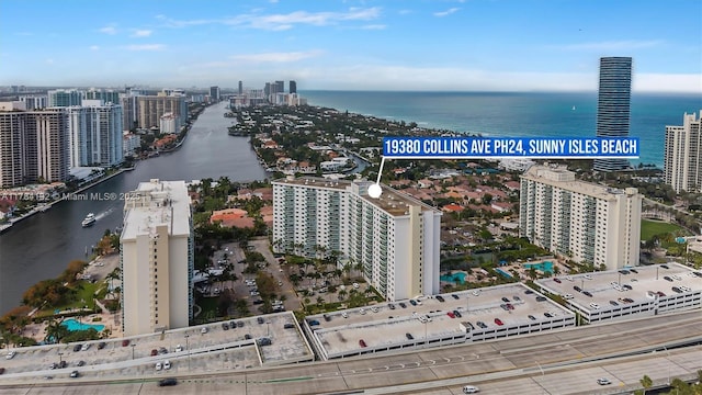 aerial view featuring a city view and a water view