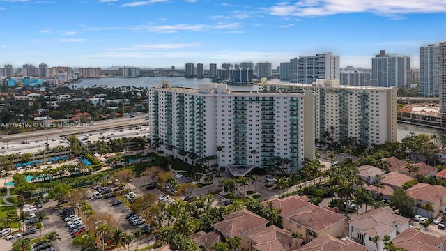 birds eye view of property with a water view and a city view
