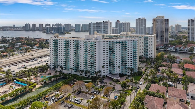 birds eye view of property featuring a city view and a water view