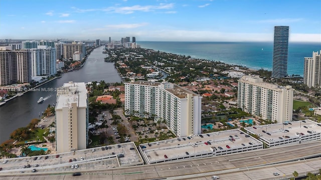 drone / aerial view with a city view and a water view